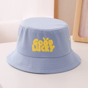 Detail view of reinforced stitching and yellow Good Lucky lettering on light blue sun hat