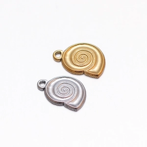 Macro view of gold and silver conch shell charms for DIY jewelry making