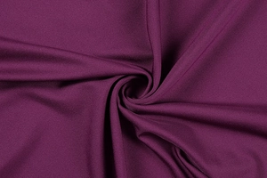 Macro view of deep burgundy dress fabric showing fine ribbed texture and soft luster