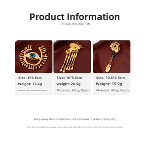 Detailed view of three vintage gold eye brooches with rhinestones and tassels on silk