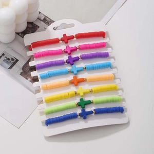 Detail of 8-piece bohemian rainbow heishi bead bracelet set with cross charms