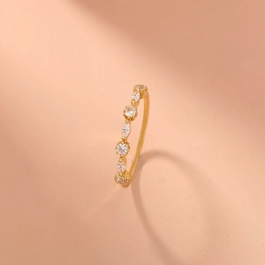 Close-up of gold plated brass ring with marquise and round cut white zircon stones