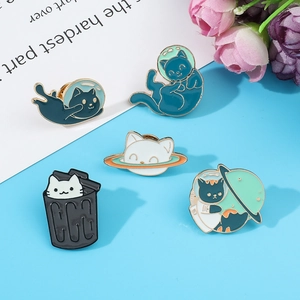 Detailed close-up of a five-piece creative enamel cat astronaut pin set on floral background