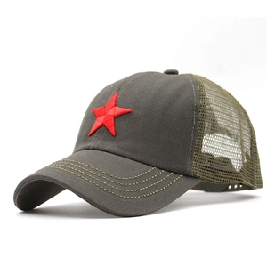 Detail showing red star embroidery on camouflage mesh trucker hat with durable stitching
