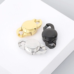 Three-color stainless steel chain clasps in gold silver and black on textured stand