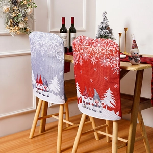 Cozy dining room setup featuring festive gnome and snowflake print Christmas chair covers