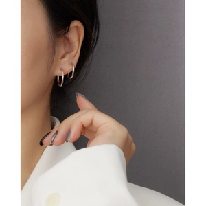Close-up of model wearing double minimalist silver hoops with a polished finish
