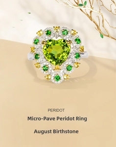 Macro shot of heart-shaped green peridot ring with micro-pave setting on dry branch