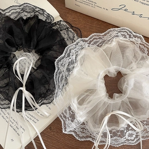 Elegant set of black and white lace scrunchies with delicate ribbon bows and ballet style