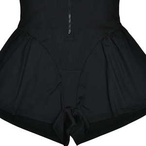 Detailed view of black bodysuit featuring front zipper design and ruched waist fabric