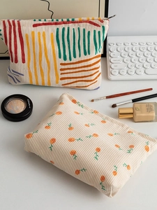 Floral corduroy makeup bags for brushes and lipsticks in a minimalist desktop setting