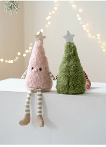 Close-up of cute plush long-legged Christmas tree dolls with stars in warm lighting
