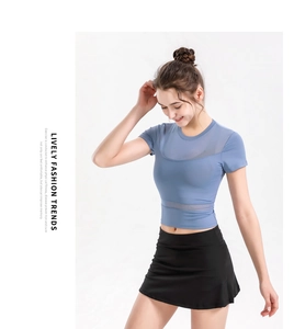 Detail of blue cropped sports top with breathable mesh panels and high-stretch fabric