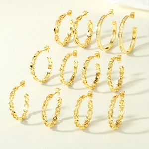 Close-up of six pairs of gold chain-style hoop earrings set with micro-pave cubic zirconia