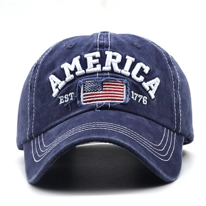 Detail of AMERICA 3D embroidery and USA flag patch on vintage washed navy cotton baseball cap
