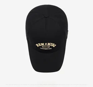 Top view of black cotton baseball cap with gold 3D embroidery showing cap crown details