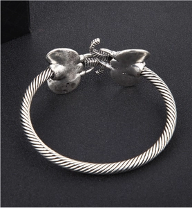 Macro view of vintage silver elephant head cuff bracelet with twisted rope texture detail