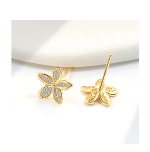 Detail of S925 sterling silver flower earrings with gold finish and zircon stones