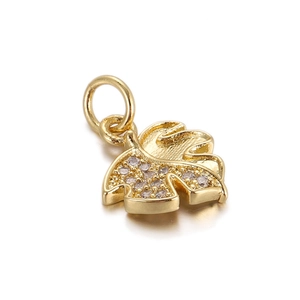 Detailed view of an 18K gold leaf pendant with sparkling zircons and delicate link ring