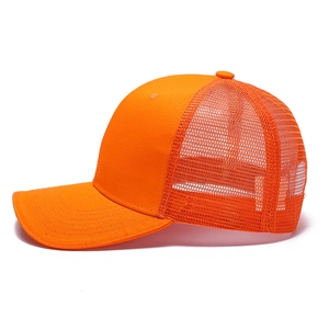 Bright orange breathable mesh trucker hat with cotton front and adjustable sun visor