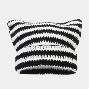 Detail of striped knit beanie with cat ears showing thick crochet texture and cuffed brim