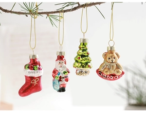 Set of glass Christmas tree ornaments featuring Santa, bear and tree on pine branches
