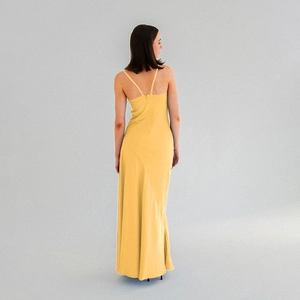 Detailed back view of a yellow satin maxi dress with slim straps and open back design