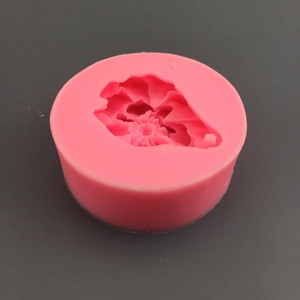 Top view of a pink silicone peony mold with intricate 3D floral details for cake decorating
