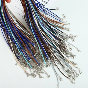 Close-up of assorted colorful wax necklace cords with lobster clasps and extension chains