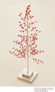 Detail of red acrylic festive tree with golden glitter finish and crystalline berries