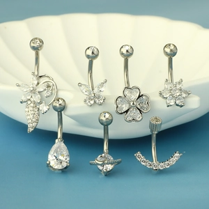 Set of seven stainless steel belly rings with sparkling clear zircons on shell tray