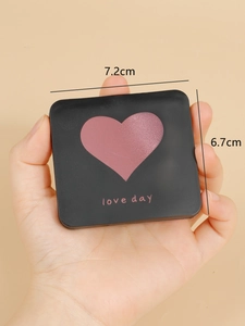 Detail view of mini black square folding mirror with purple heart and love day text
