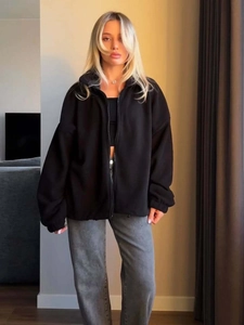 Detail view of the soft black fleece fabric and zipper on this women's sport hoodie