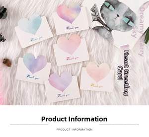 Macro detail of gradient heart Thank You cards on a soft white faux fur background