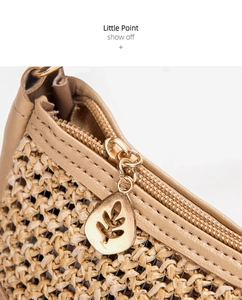 Close-up of woven straw texture with leather trim and leaf-shaped metal zipper puller