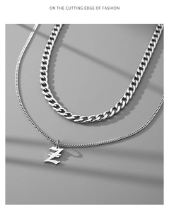 Detail view of silver double-layered stainless steel Cuban chain with letter Z pendant