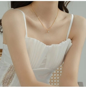 Close-up of minimalist green aventurine necklace with 18K gold-plated chain on neck