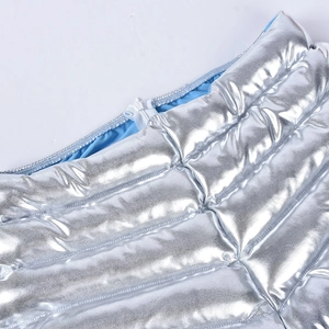 Detail of silver metallic quilted fabric with zipper closure and light blue lining