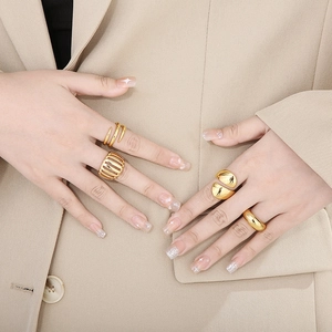 Detail of vintage style gold-toned hollow rings with spiral and dome patterns for women