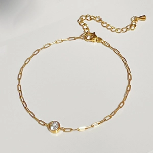 Detail of gold zircon bracelet with lobster clasp, extender chain and teardrop pendant