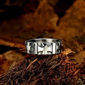 Vintage silver cross floral ring with wide band and carved relief on wood background