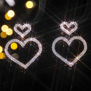 Macro view of luxury heart earrings featuring double hearts with glittering rhinestones