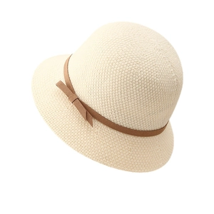 Elegant beige knitted cloche hat with brown bow tie detail and breathable texture