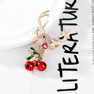 Festive Christmas reindeer brooch with sparkling rhinestones and red jingle bells