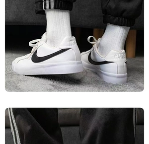 Gros plan de baskets en cuir blanc avec logo noir sur un tapis gris moderne