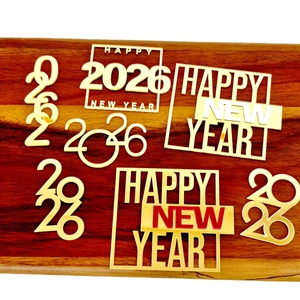 Gold acrylic 2026 Happy New Year cake toppers set displayed on dark wood background
