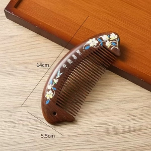 Detail view of sandalwood massage comb with floral pattern and size dimensions 14x5.5 cm