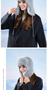Winter thermal knit hat with gray-blue faux fur earflaps and mountain view background