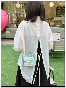 Mint green quilted jelly bag detail showing PVC texture and golden chain strap