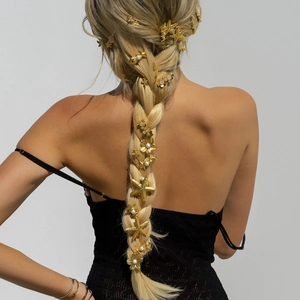 Golden starfish and flower hair clips with pearls on braided hair for beach style